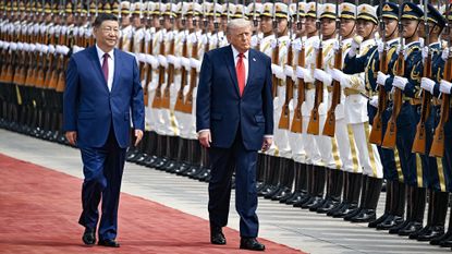 US President Donald Trump and China's President Xi Jinping inspect a guard of honour during a welcome ceremony at the Great Hall of the People in Beijing