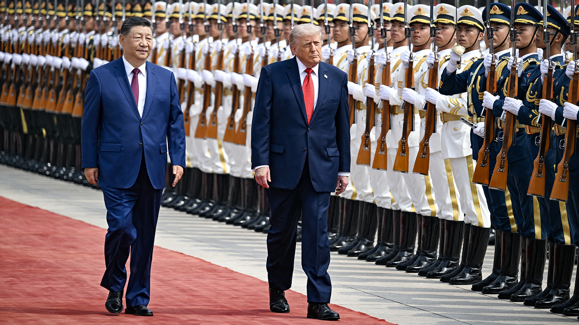 US President Donald Trump and China's President Xi Jinping inspect a guard of honour during a welcome ceremony at the Great Hall of the People in Beijing