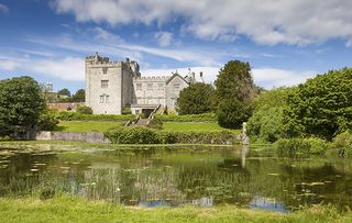 View across the Lake to the South East Front of Sizergh Castle, Cumbria, in June.