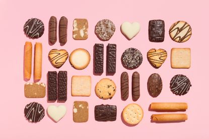 A selection of biscuits on a pink background ranked from healthiest to worst