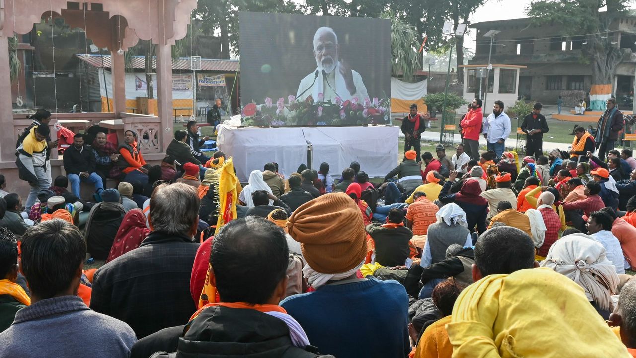 People watch a screen as India&#039;s Prime Minister Narendra Modi officially consecrates the Ram temple, in Ayodhya 