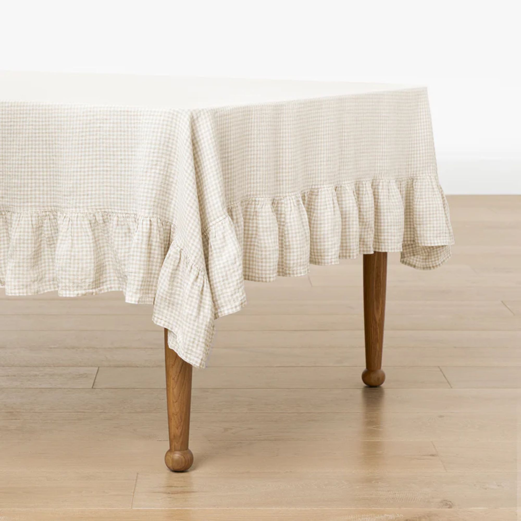 Tablecloth with taupe and white micro gingham print and ruffled edges