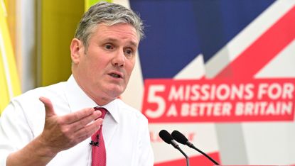 Keir Starmer in front of sign saying ‘5 Missions for a Better Britain’