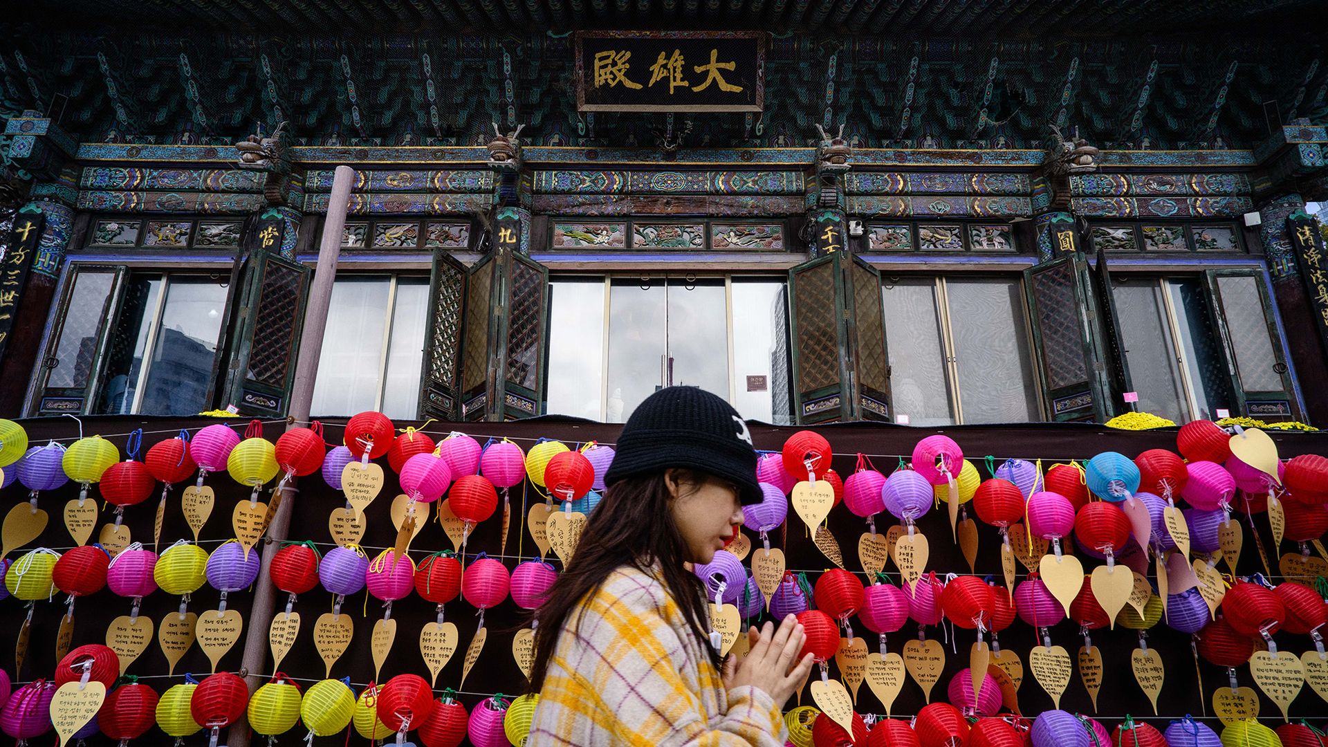 
                                A Buddhist prays at the Bongeunsa Temple as students sit for the annual college entrance exam in Seoul, South Korea
                            