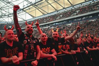 Fans of Australian rock band AC/DC cheers at their "PowerUp Tour 2024" at the VELTINS-Arena in Gelsenkirchen, western Germany on May 17, 2024