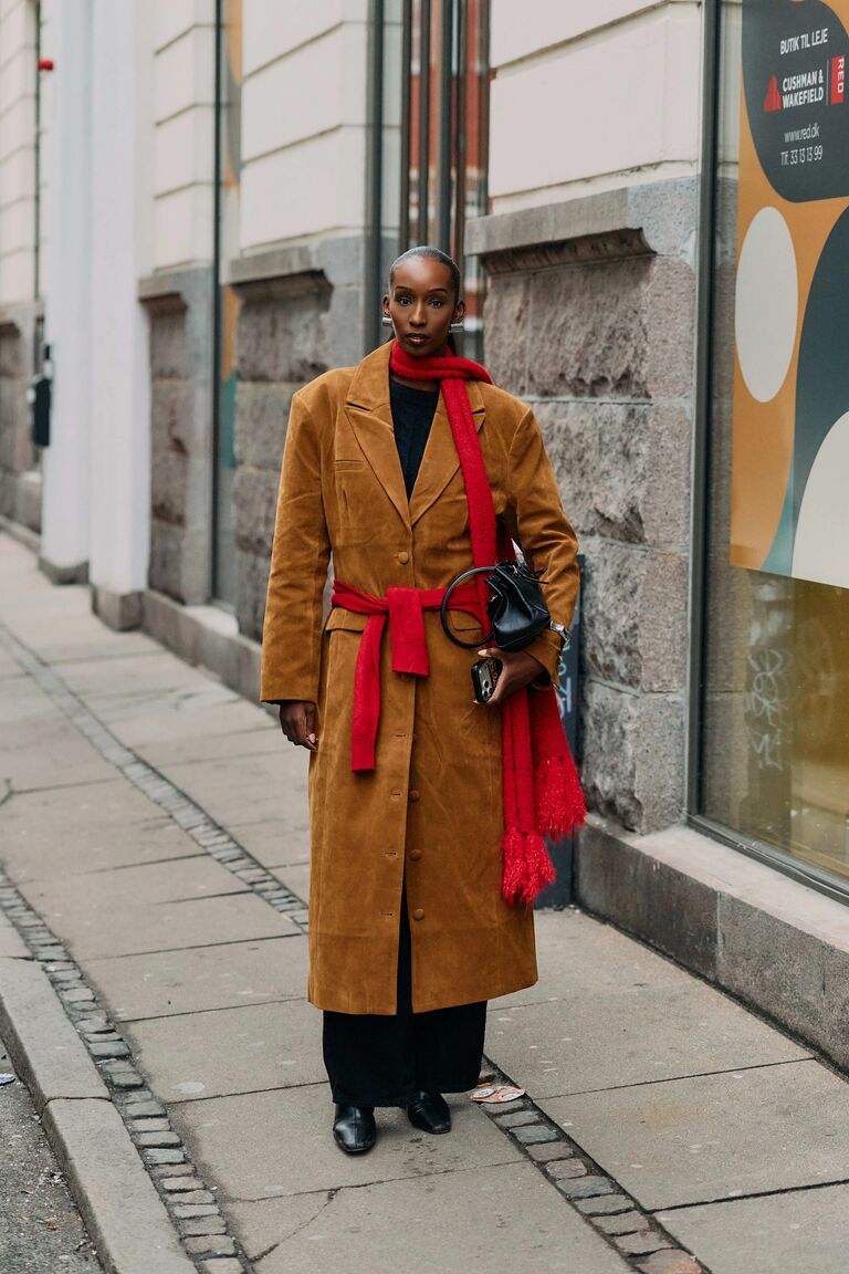 Photo of woman wearing coat at Copenhagen Fashion Week.