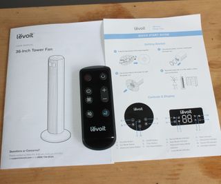 A close-up of the remote and instructions of the Levoit 36 Inch Tower Fan