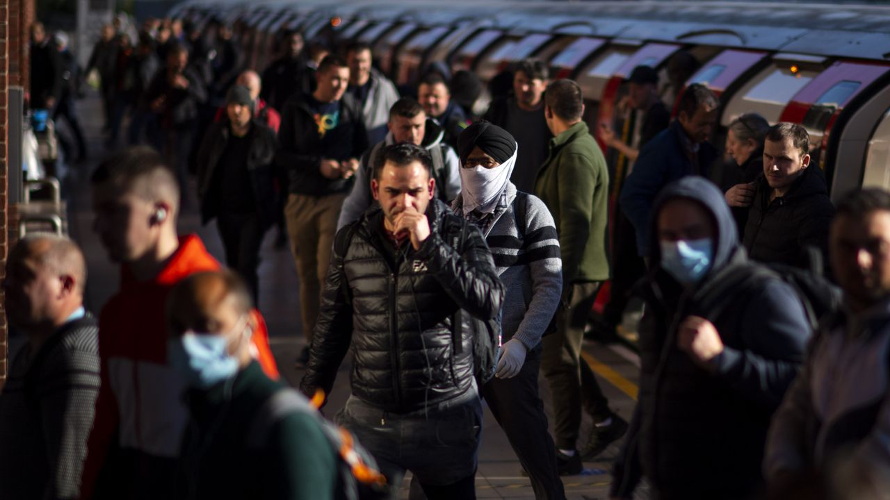 Commuters exit the tube at West Ham station in East London