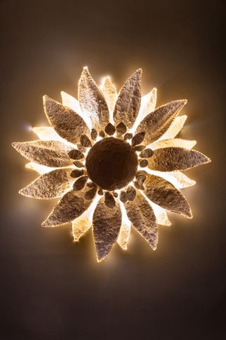 A flower sculpture decorated with lights