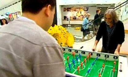 Two dudes play a game of foosball in IKEA's Manland, an adult play area for those bored husbands and boyfriends.
