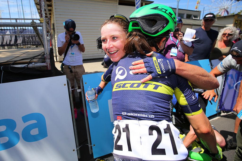Annemiek van Vleuten hugs it out with her Orica-Scott teammates