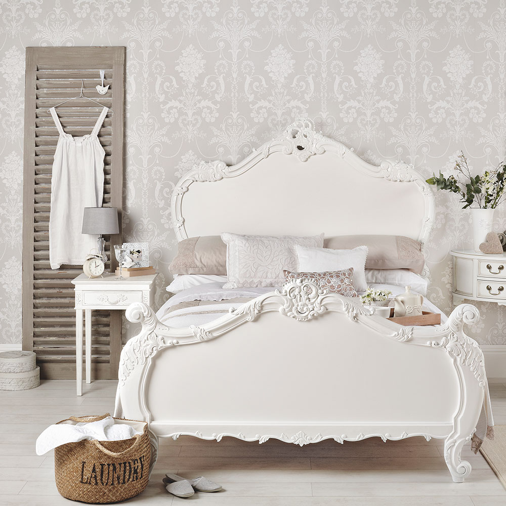 bedroom with patterned wallpaper and basket