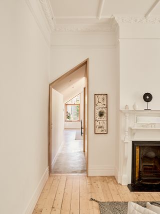 white living room with angular arched wood door frame