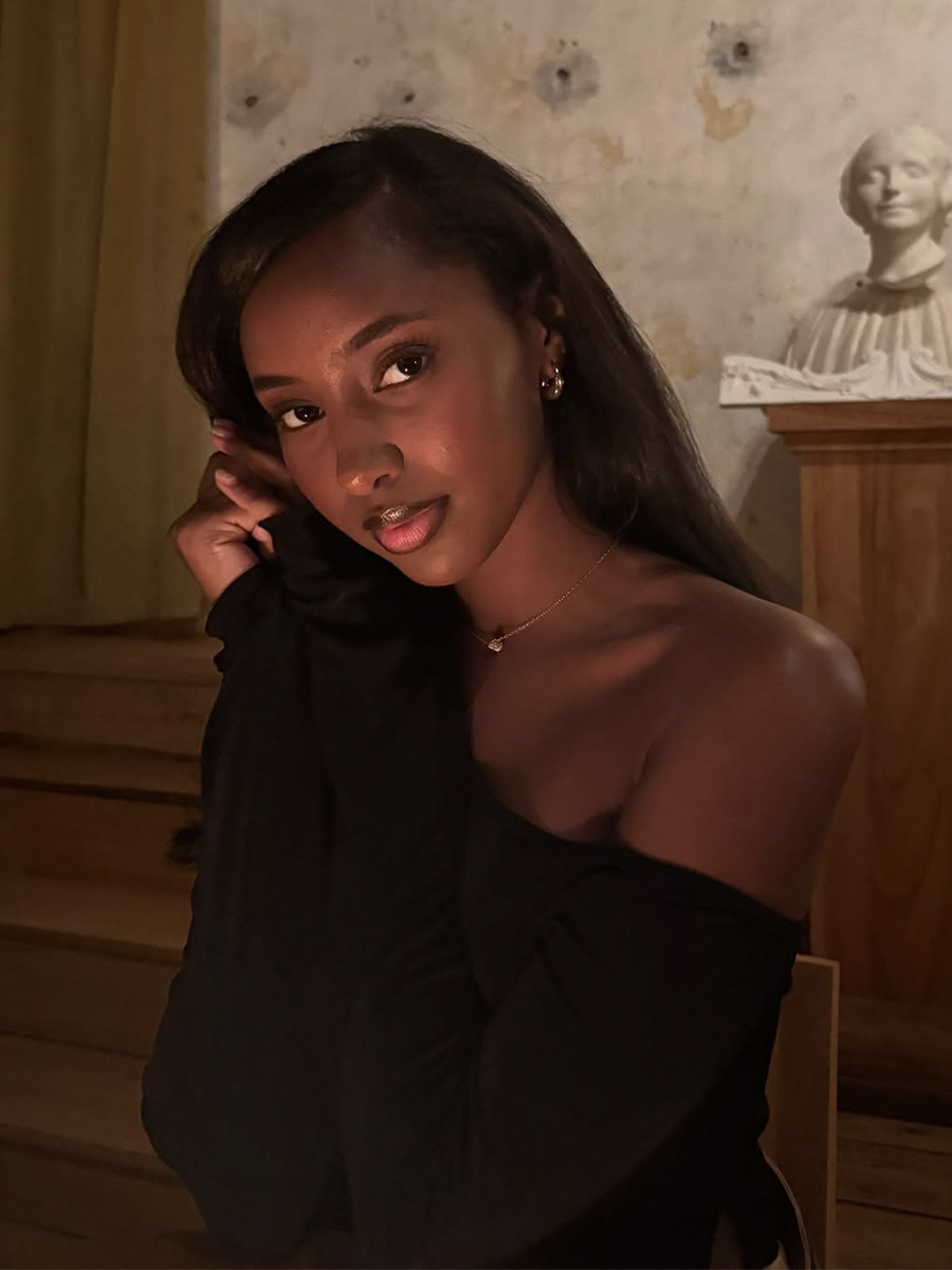 Rayan Xasan poses with glowy skin and a brown lip color