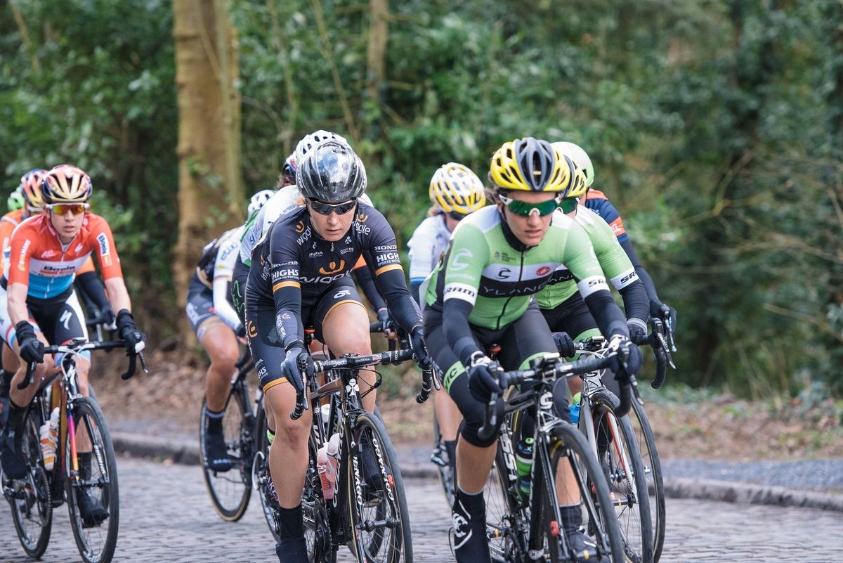 Amy Pieters well positioned as the lead group charge across the cobbles