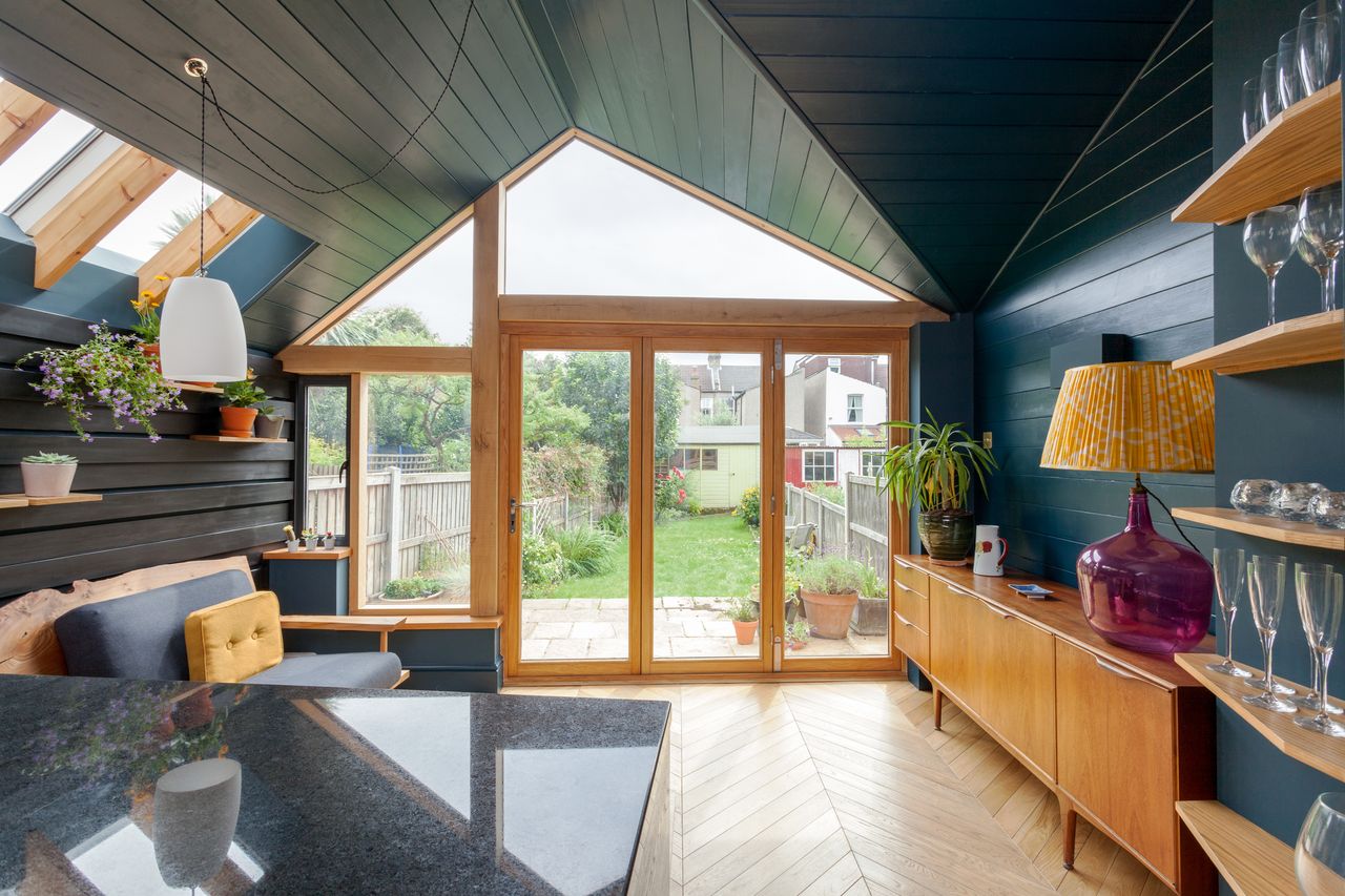 A timber frame extension with a view towards the bifold doors and garden