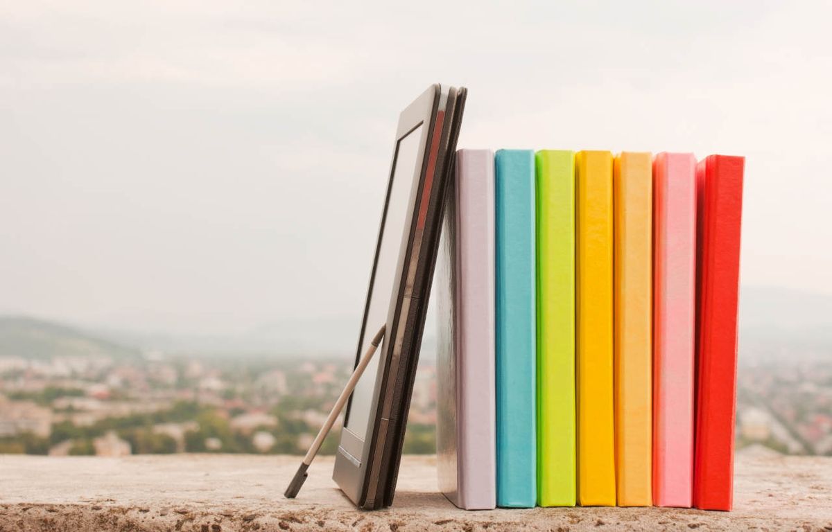 Row of colorful books with electronic book reader