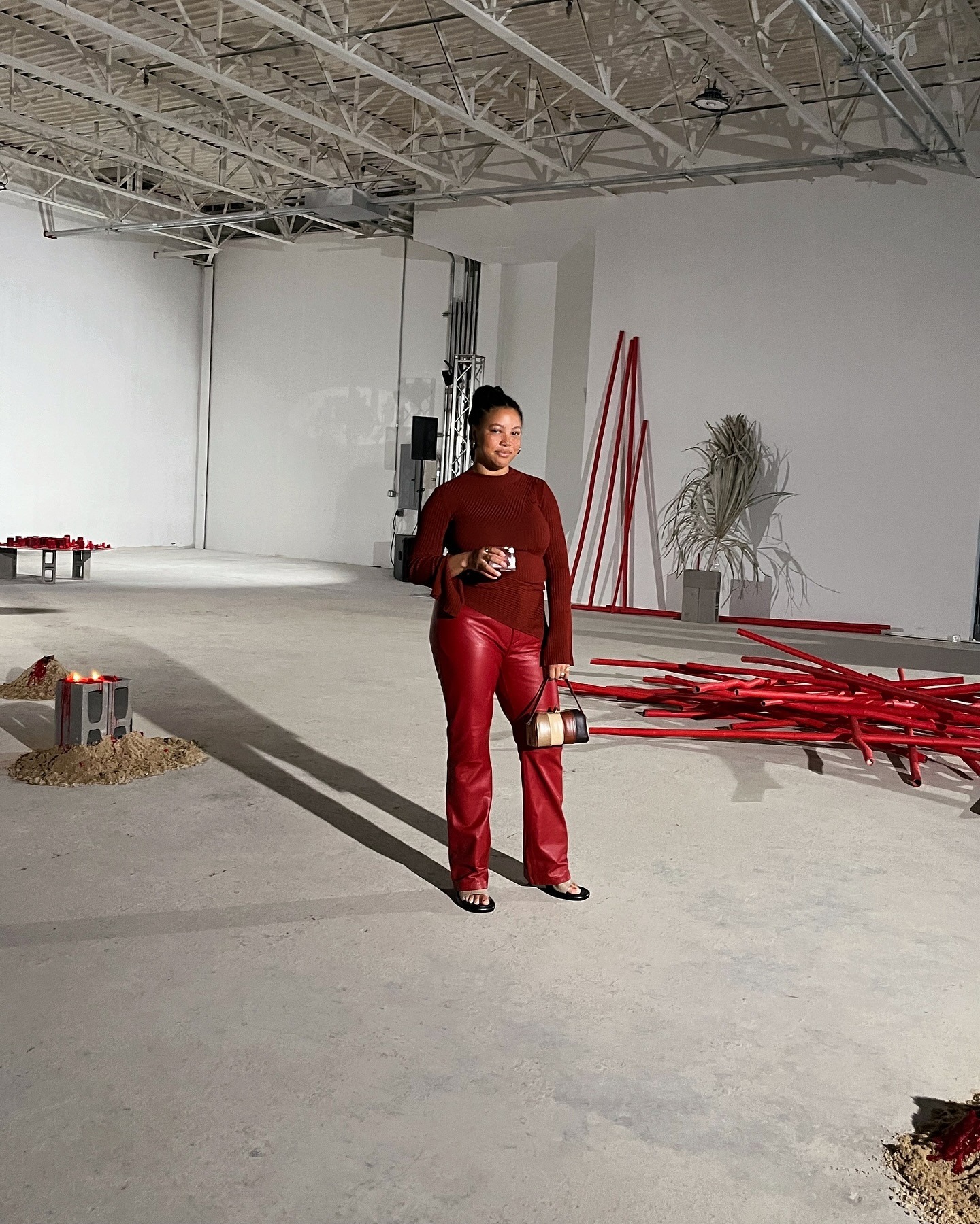 A woman wearing a red sweater and red pants.