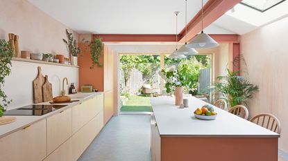 Terracotta peach kitchen with long island and exposed beams