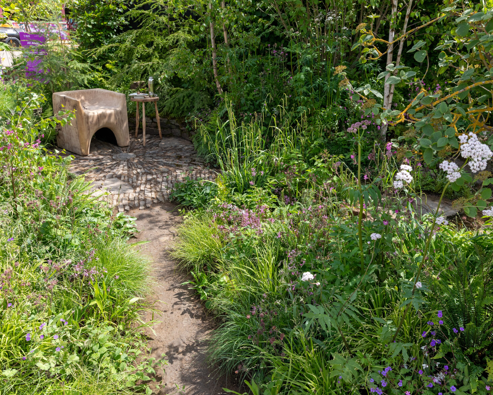 solitary wooden chair in a show garden at RHS Chelsea Flower Show 2026