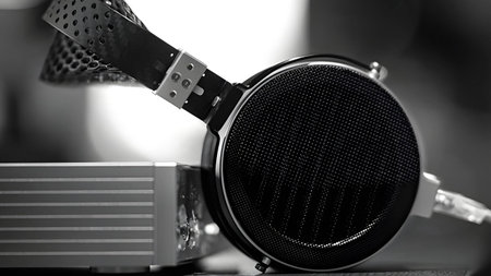 Moondrop Skyland headphones resting on their aluminium protective case