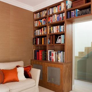 wooden book shelves with sofa and cushions