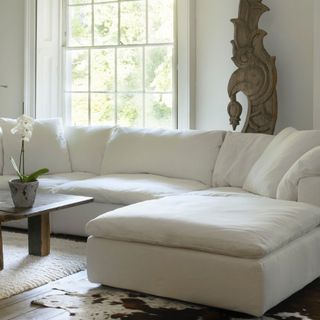 White l-shaped sofa in white living room