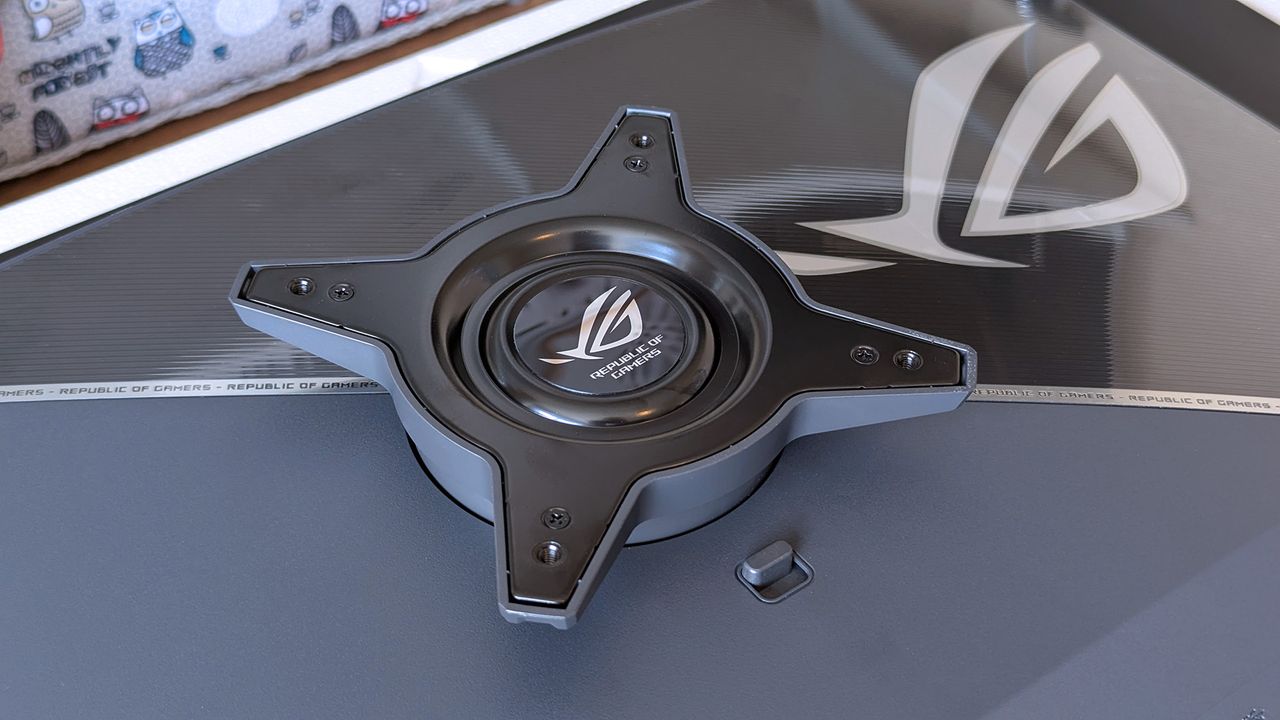 ASUS ROG Strix OLED rear mounting bracket with the central ROG logo and four‑point screw mount.