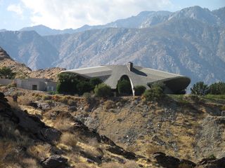 Discrete view of house roof between the mountains
