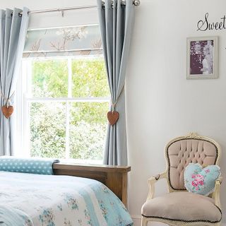bedroom with grey curtain and roman blinds