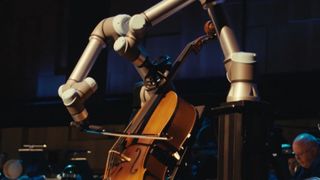 A pair of robot arms playing the cello with the Malmö Symphony Orchestra