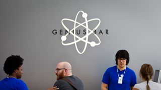 D.J. Warren, center, of Houston talks to an Apple Store associate as he visits the Genius Bar at Highland Village shopping mall Monday, March 19, 2012, in Houston. ( Nick de la Torre / Houston Chronicle )