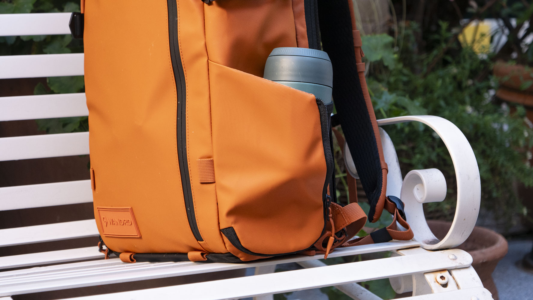 Wandrd PRVKE V4 bag on a white metal bench 