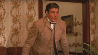 Christopher Reeve stands surprised while dressed in period garb in Somewhere In Time.