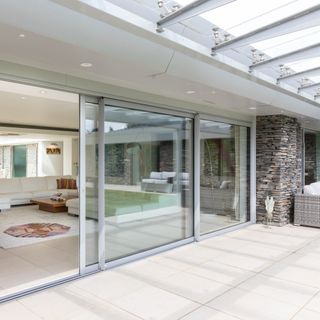 Glass sliding doors to patio with grey frame