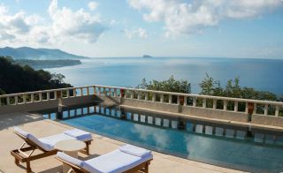 An image showing the pool, with the sea and mountains in view