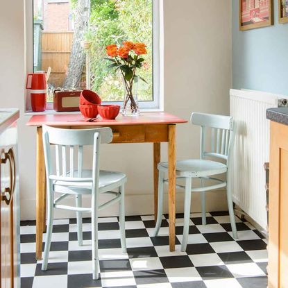 kitchen room with wooden table having flower in vase