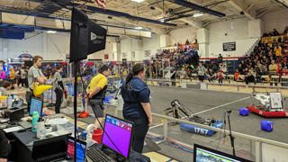 The First Robotics tournament with robots in action and an RF Venue Diversity Fin wireless antenna providing coverage.
