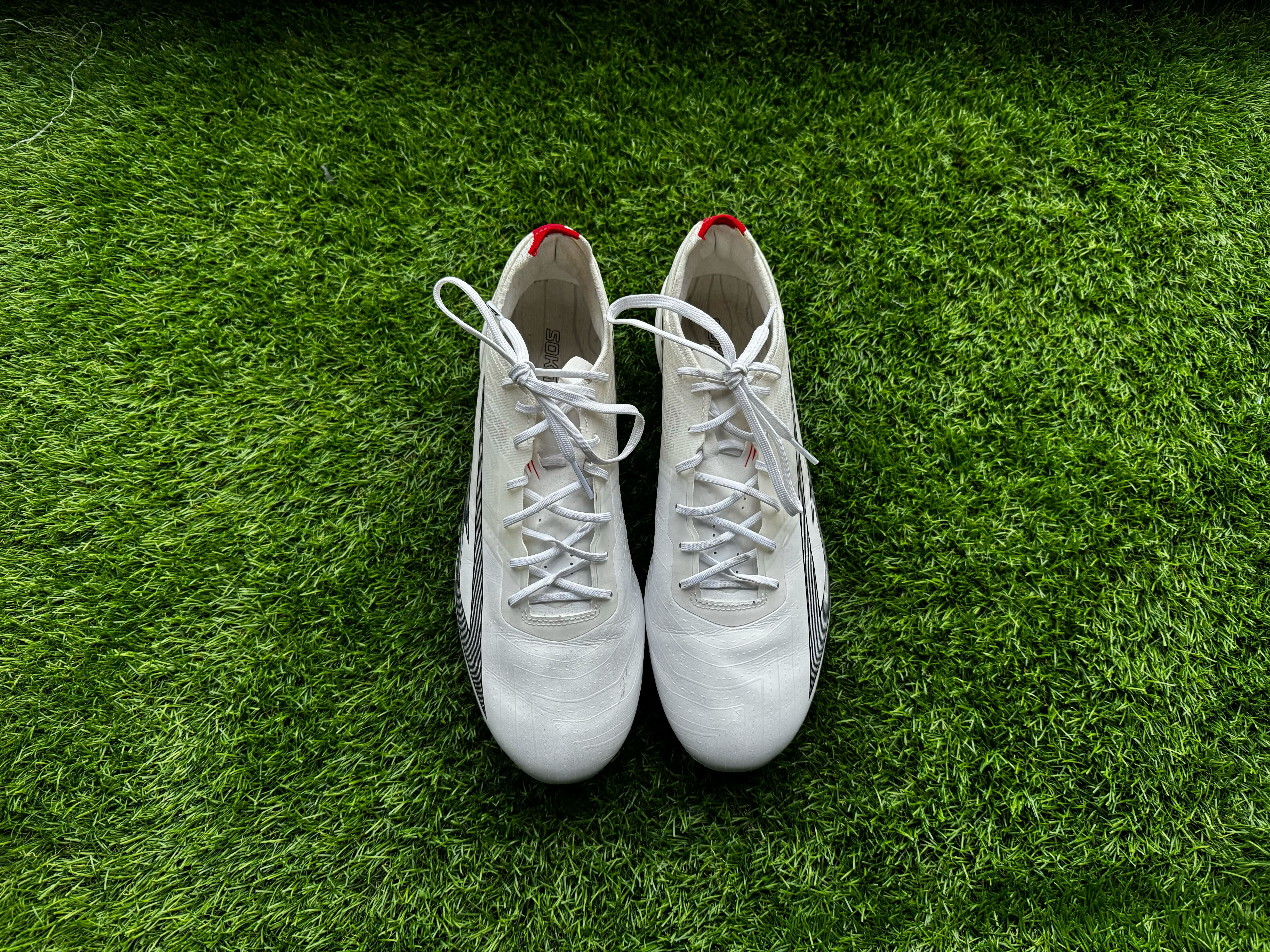 Sokito Scudetta football boots reviewed. The boots are placed on a piece of turf ahead of being reviewed.