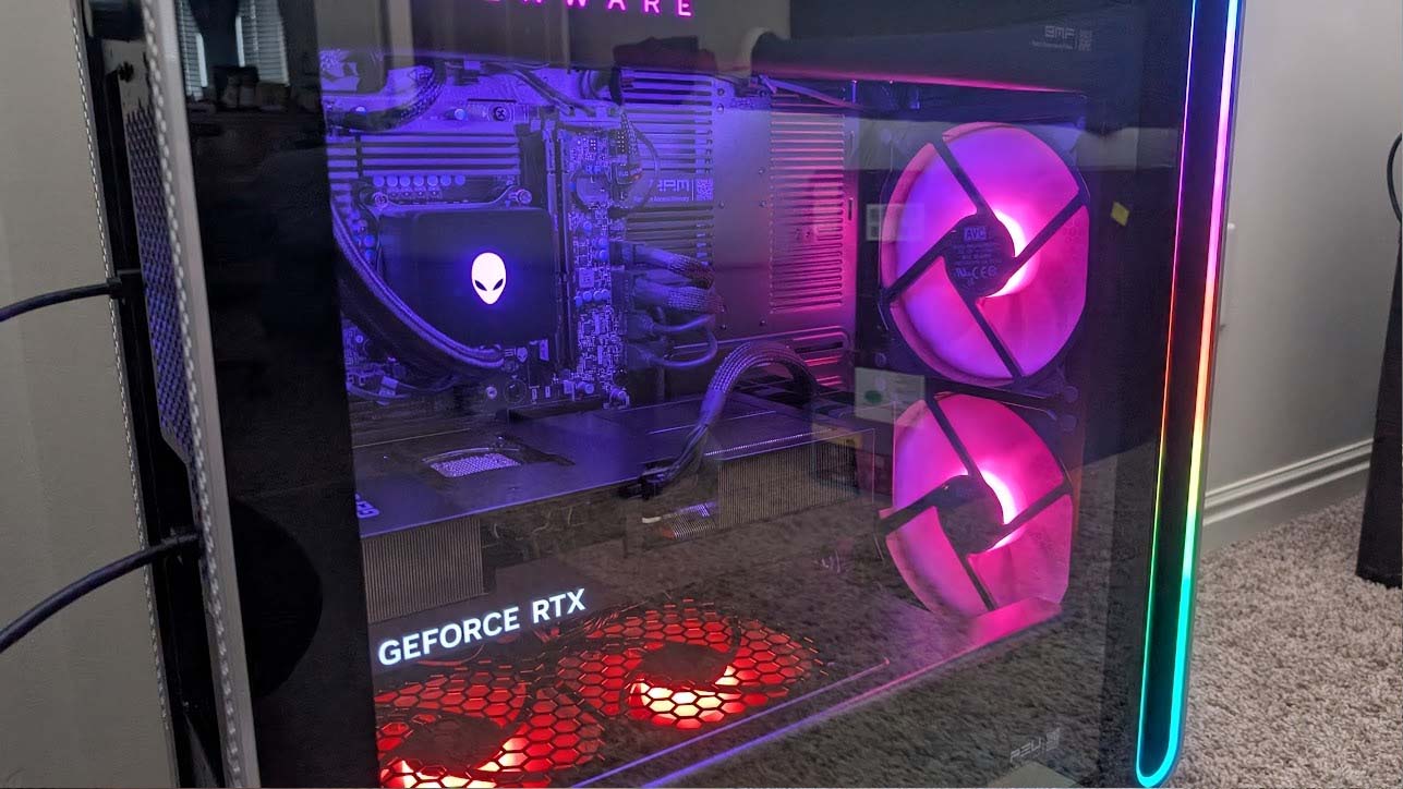 Original image of the Alienware Area-51 Desktop with RGB lighting highlighting fans, GPU, and other internals. There are distracting reflections on the glass.