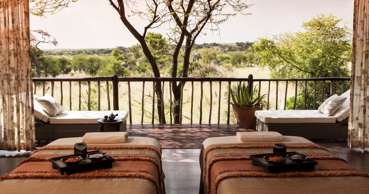 Image of a spa room with two spa beds and a wall that is open to an outdoor porch in the Serengeti