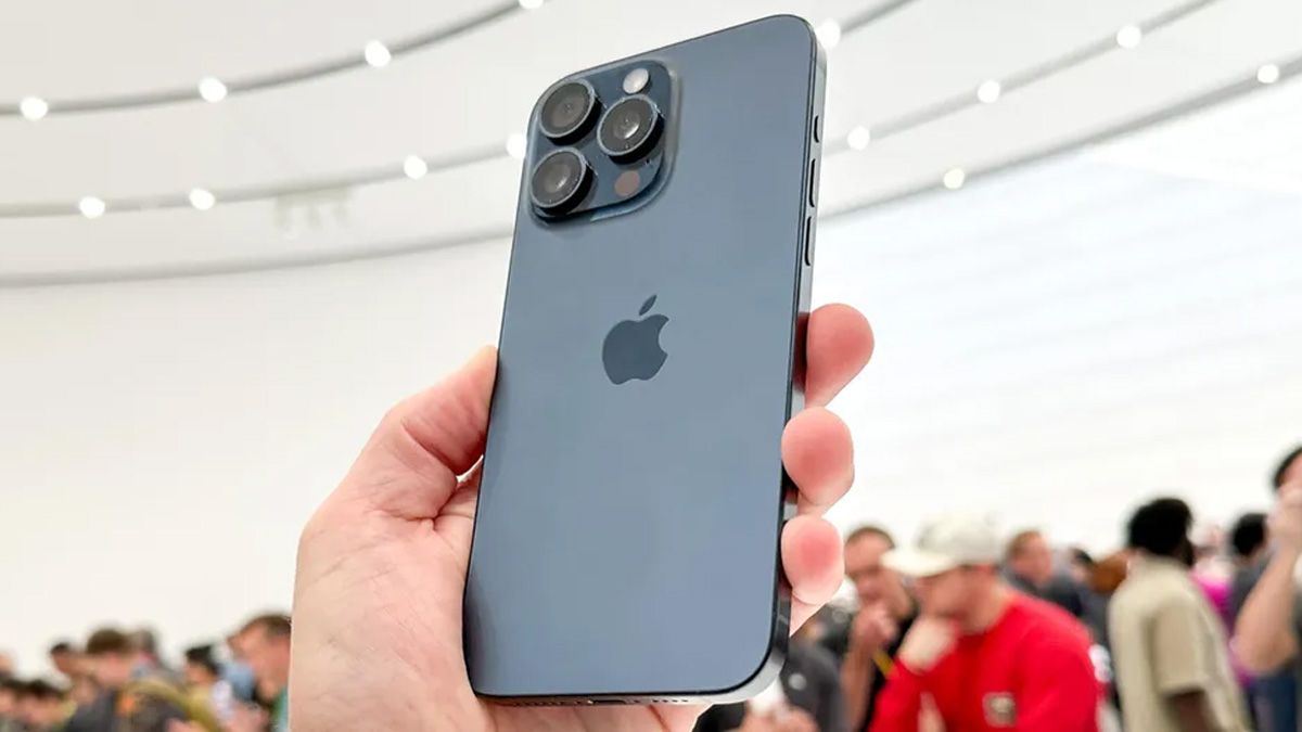 Silver iPhone model being held at an event.