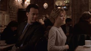 Tom Hanks and Meg Ryan sit in a cozy New York City cafe in You've Got Mail