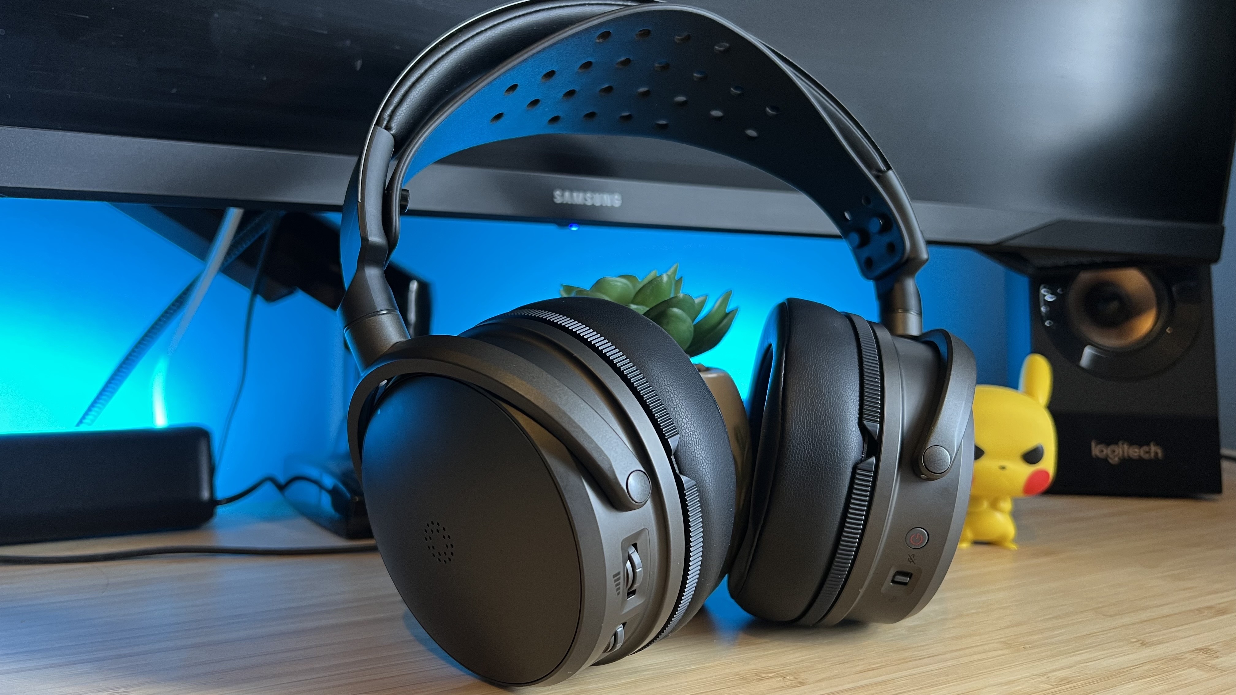 Audeze Maxwell 2 gaming headset on a wooden desk with blue backlighting