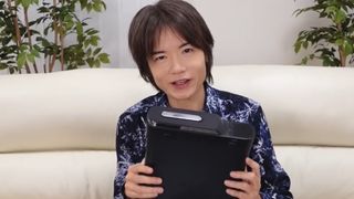 Masahiro Sakurai with his dead Xbox 360