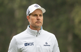 Henrik Stenson wearing a white sweater and cap