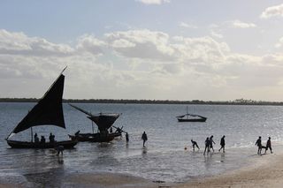 Fishermen set sail into the waters off of Mozambique's coast.