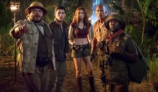 Jumanji: Welcome To The Jungle Dwayne Johnson and cast look into the distance