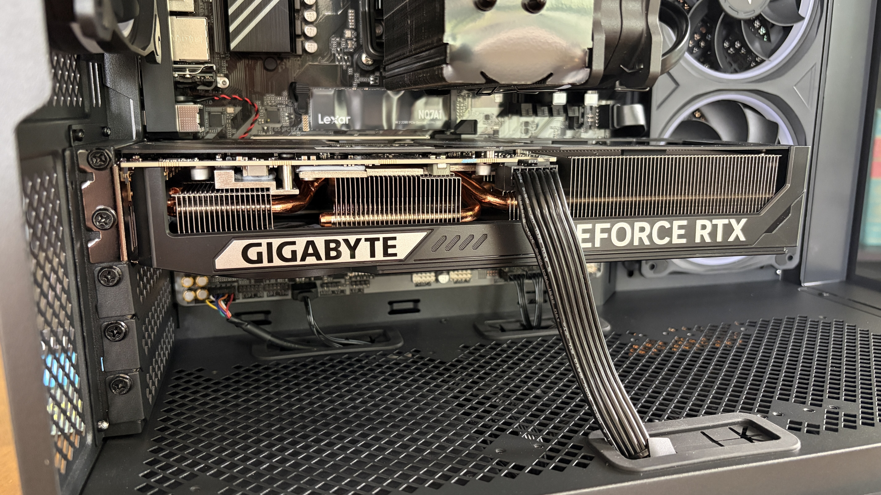 Interior of a Nitro 65 computer case showing a GIGABYTE GeForce RTX graphics card with cooling fins, circuit board components, and visible wiring.
