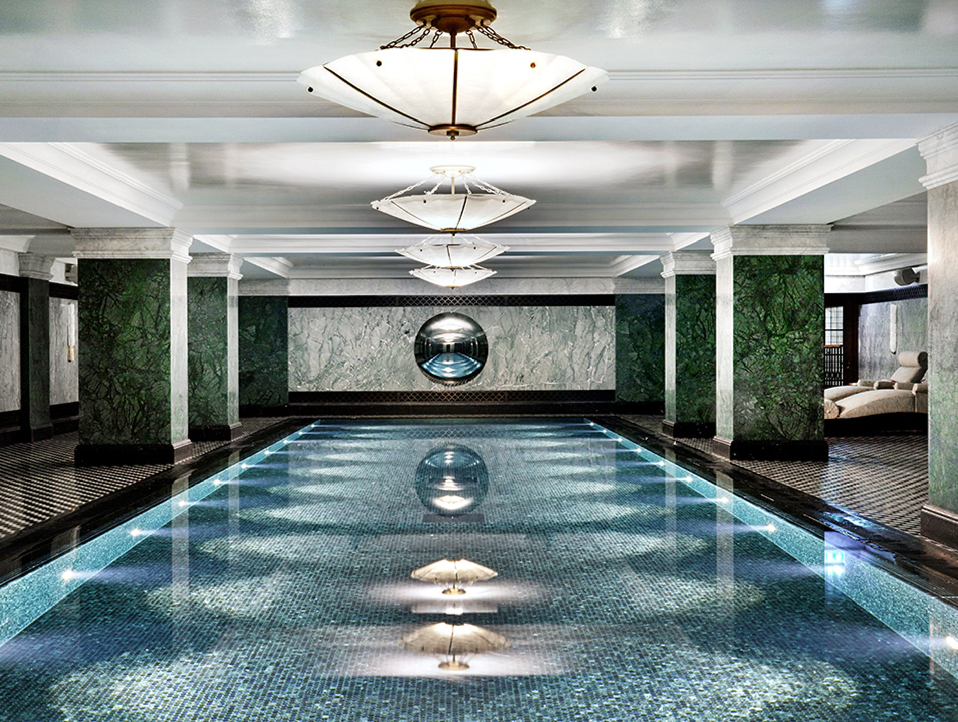 The Ned London spa pool with blue tiles and marble pillars